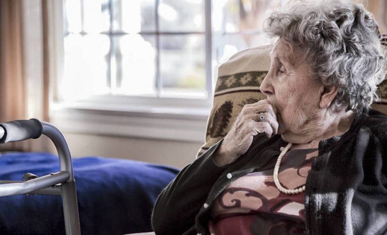 portrait-of-an-elderly-woman-sitting-alone-in-a-senior-care-facility