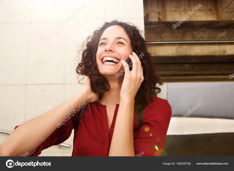 attractive young woman talking on cell phone on laughing