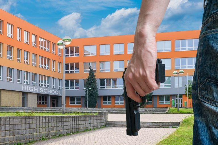 Gun Control Concept. Young Armed Man Holds Pistol In Hand In Pub