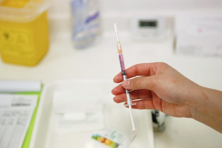 FILE PHOTO: A nurse prepares a vaccine to be given to a child in a hospital in Beijing
