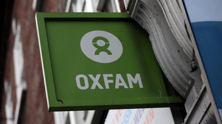 A sign is seen above a branch of Oxfam in central London