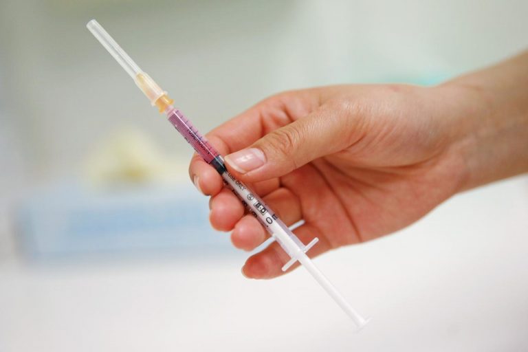 FILE PHOTO: A nurse prepares a vaccine to be given to a child in a hospital in Beijing