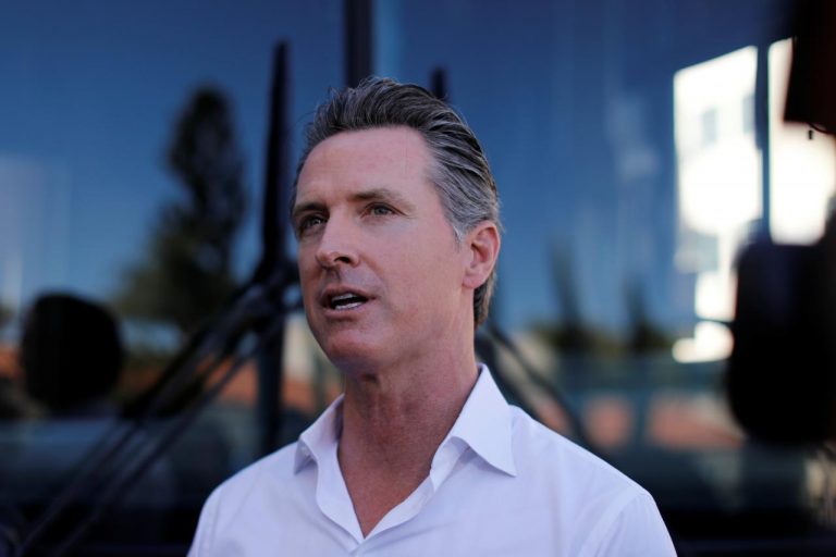 FILE PHOTO: Democratic gubernatorial frontrunner Gavin Newsom speaks to the media before getting on his bus as he campaigns at San Diego