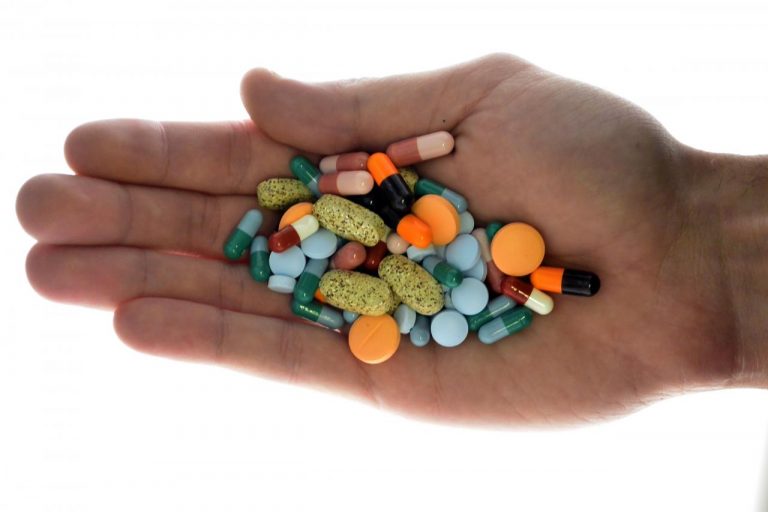 FILE PHOTO:  A person holds pharmaceutical tablets and capsules in illustration picture in Ljubljana