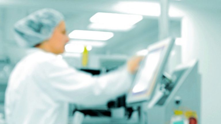 White box at automated production line at modern factory, people