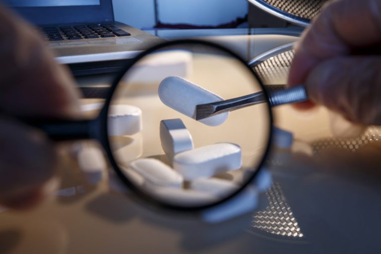 Tablets and a chemical on the laboratory table