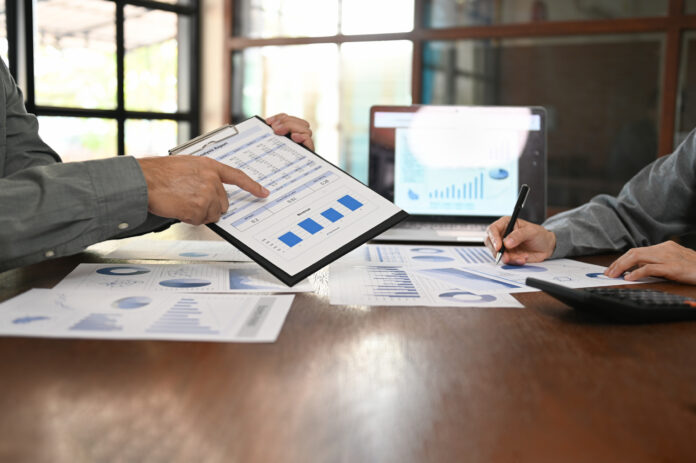 Business and Financial concept. Business team discussing assessment
and evaluation of corporate showi results of successful teamwork.